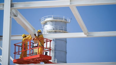Two engineers on crane doing maintenance work