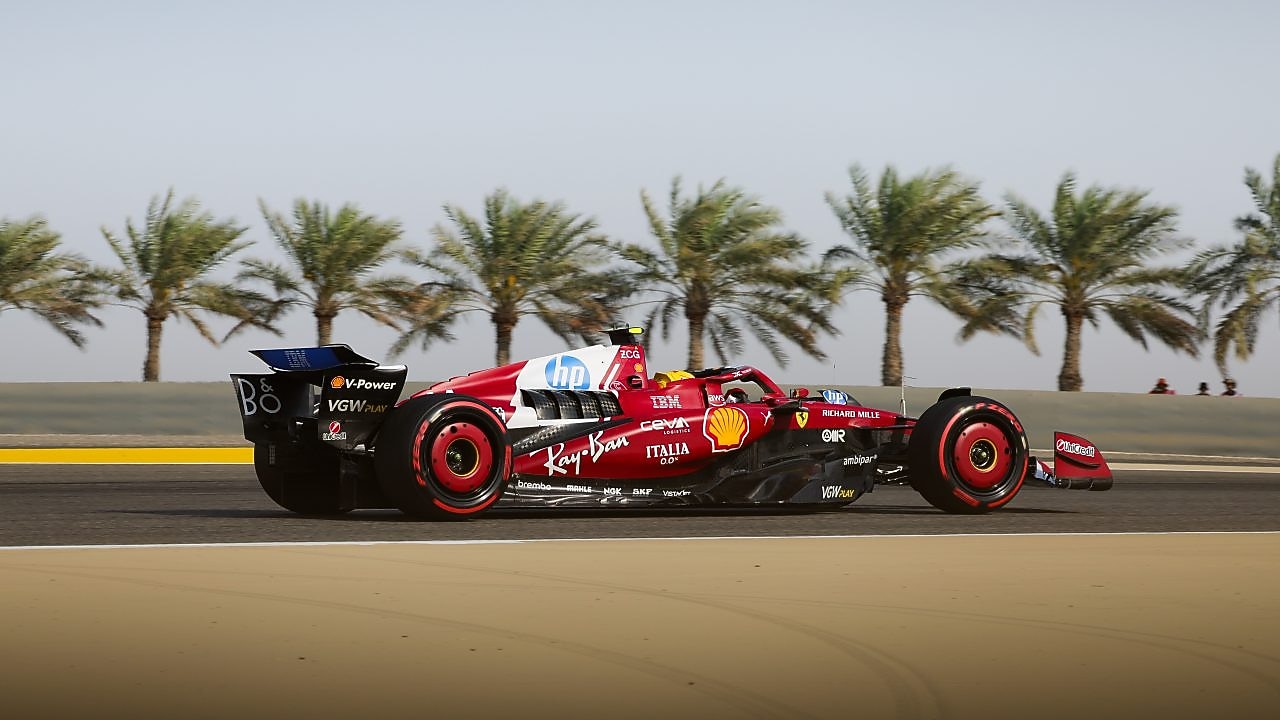 Ferrari F1 car racing on sunny track with palm trees