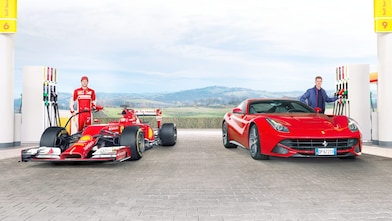 Sebastian Vettel y Kimi Raikkonen llenan sus Ferraris en una estación de Shell